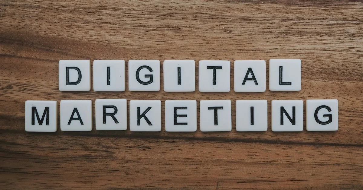 Letter tiles spelling digital marketing on a wooden table